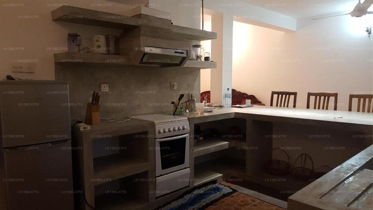 Modern kitchen with white appliances and wooden cabinets.